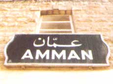 Ortsschild Amman an einer Hauswand